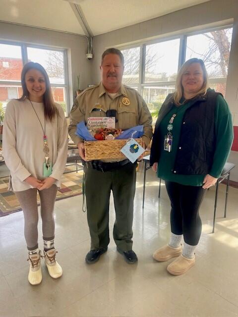 SRO officer receiving a gift basket 